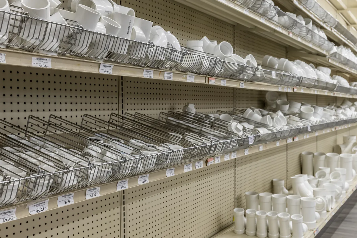 Plumbing fittings organized along a store aisle